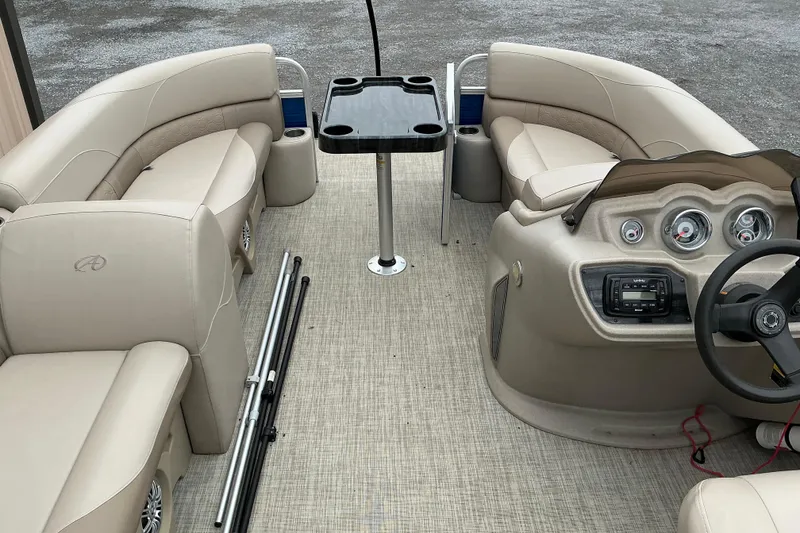 Slide: The Image of Interior of 2018 Avalon GS Cruise II pontoon boat with beige seating and control panel. - 10
