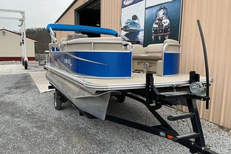 Slide: The Image of 2018 Avalon GS Cruise II 19' pontoon boat on trailer near storage facility. - 3