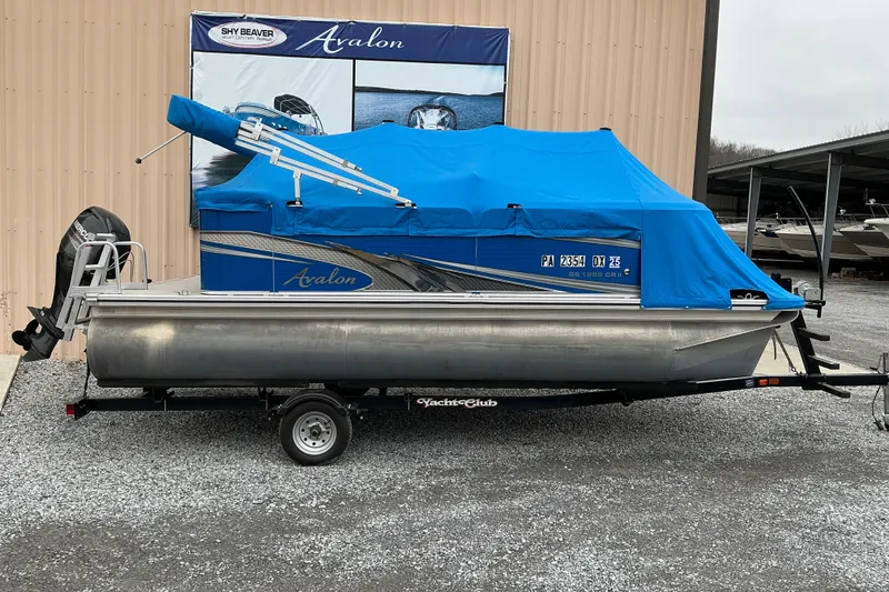 Slide: The Image of 2018 Avalon GS Cruise II 19' pontoon boat with blue cover on trailer. - 5