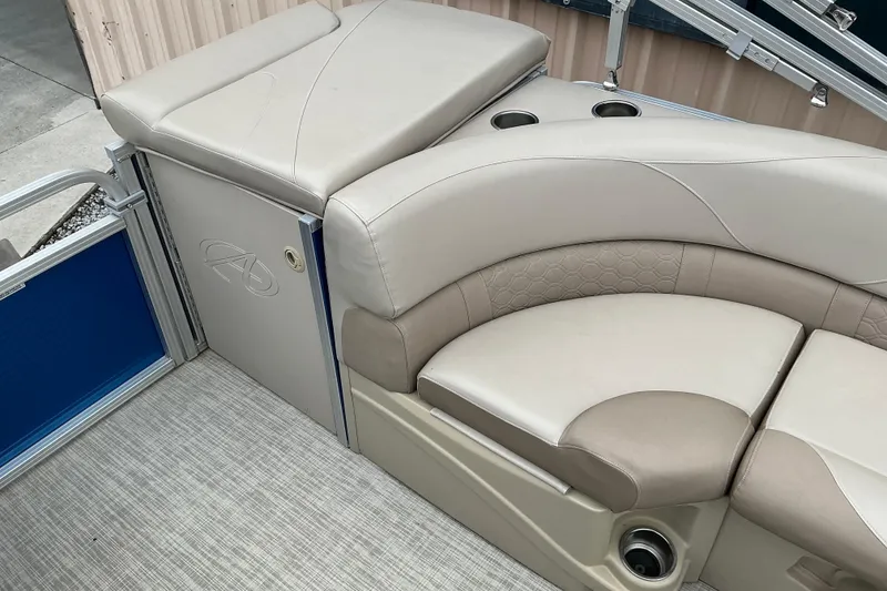 Slide: The Image of 2018 Avalon GS Cruise II 19' boat interior with beige seating and cup holders. - 9