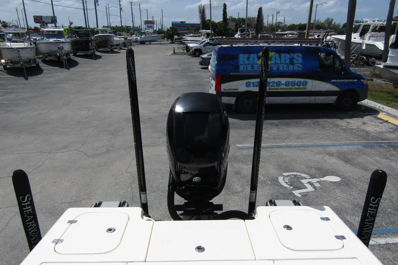 Slide: The Image of 2023 ShearWater 260 Carolina Flare boat with outboard motor in a parking lot. - 12