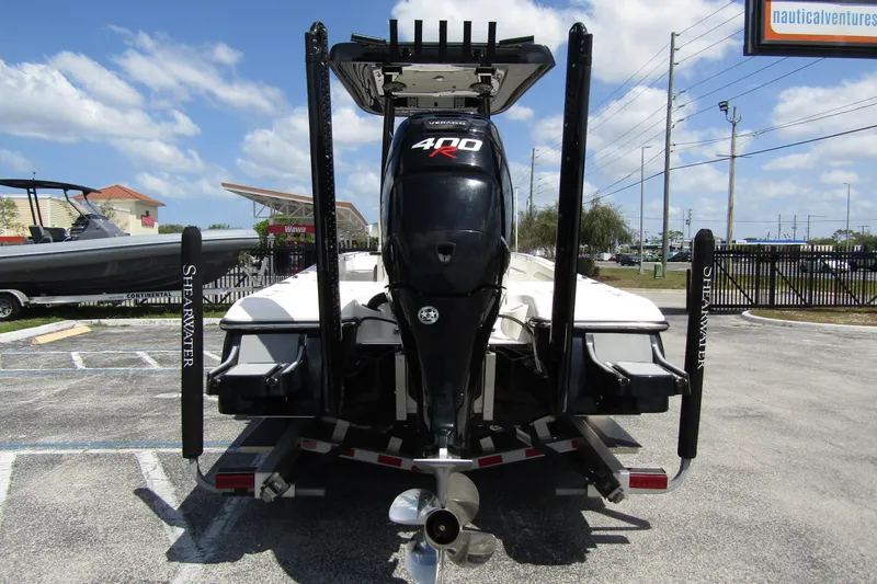 Slide: The Image of 2023 ShearWater 260 Carolina Flare boat with powerful 400R engine, parked outdoors. - 2
