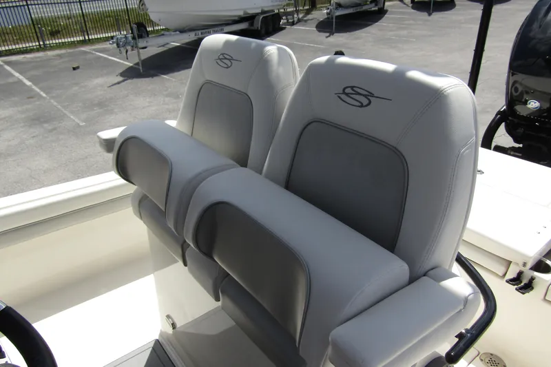 Slide: The Image of 2023 ShearWater 260 Carolina Flare boat seats, featuring sleek gray upholstery and ergonomic design. - 21