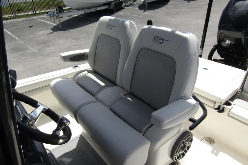 Slide: The Image of 2023 ShearWater 260 Carolina Flare boat seats with armrests and steering wheel. - 22