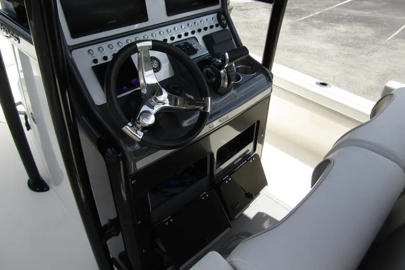 Slide: The Image of 2023 ShearWater 260 Carolina Flare boat console with steering wheel and controls. - 24