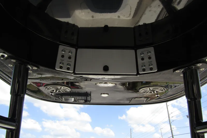 Slide: The Image of 2023 ShearWater 260 Carolina Flare boat console with speakers and controls under a clear sky. - 26