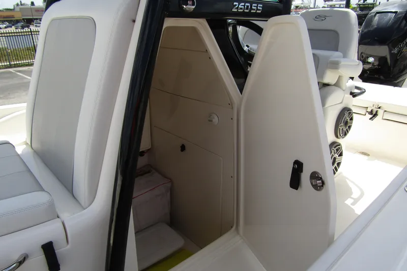 Slide: The Image of 2023 ShearWater 260 Carolina Flare boat interior with seating and storage area. - 29