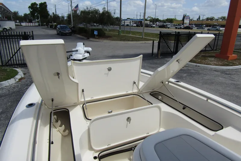 Slide: The Image of 2023 ShearWater 260 Carolina Flare boat with open storage compartments, parked outdoors. - 35