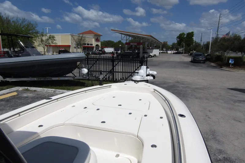 Slide: The Image of 2023 ShearWater 260 Carolina Flare boat parked near a gas station under a blue sky. - 44