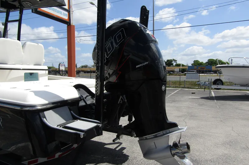 Slide: The Image of 2023 ShearWater 260 Carolina Flare boat with Mercury outboard motor in parking lot. - 5