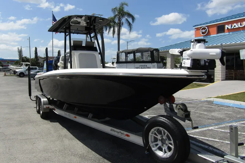 Slide: The Image of 2023 ShearWater 260 Carolina Flare boat on trailer, parked outdoors under blue sky. - 7
