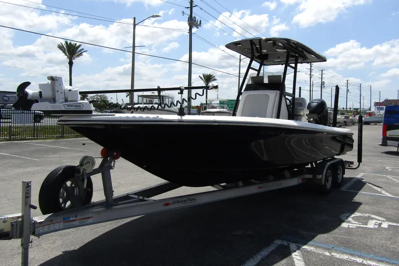 Slide: The Image of 2023 ShearWater 260 Carolina Flare boat on trailer, parked outdoors under a sunny sky. - 8