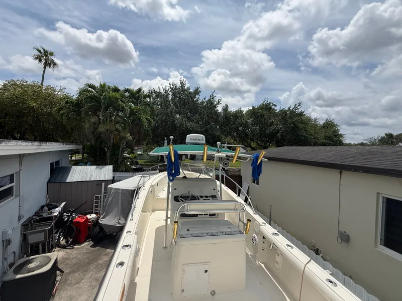 Slide: The Image of 1999 Pursuit 2870 Center Console boat parked in backyard. - 18