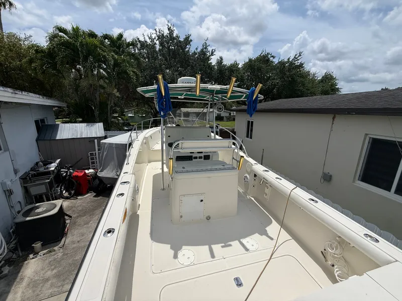 Slide: The Image of 1999 Pursuit 2870 Center Console boat parked in backyard. - 33