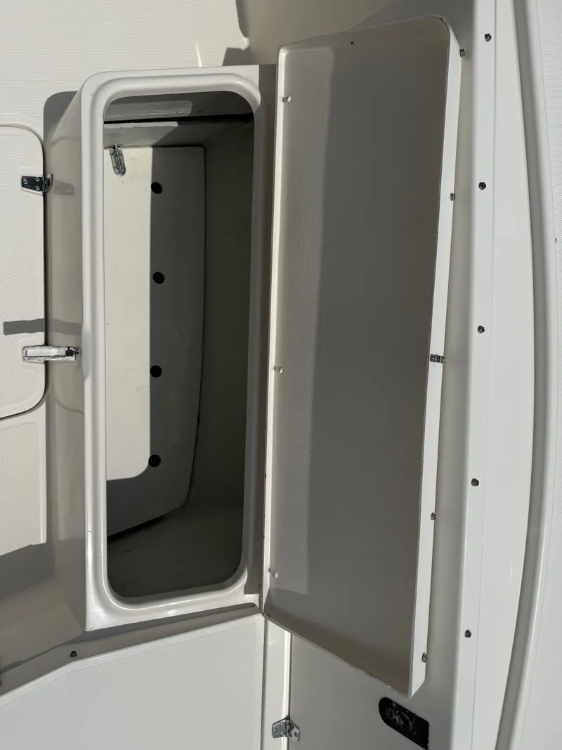 Slide: The Image of Open storage compartment on a 1999 Pursuit 2870 Center Console boat. - 42