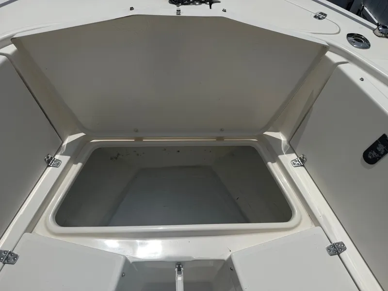 Slide: The Image of Open storage compartment on a 1999 Pursuit 2870 Center Console boat. - 43