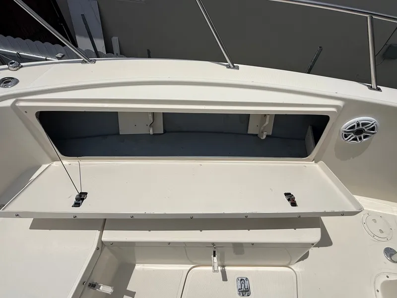Slide: The Image of Open storage compartment on a 1999 Pursuit 2870 Center Console boat. - 45