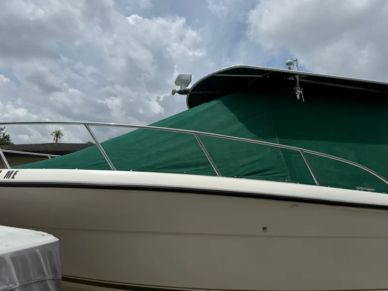 Slide: The Image of 1999 Pursuit 2870 Center Console boat with green cover. - 6