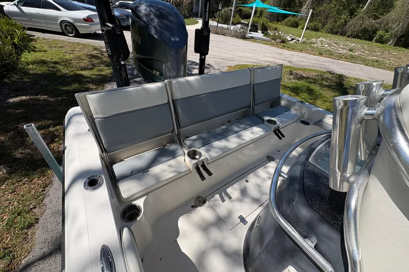 Slide: The Image of 2018 ShearWater 26 Carolina boat interior with seating and Yamaha V8 engine. - 10