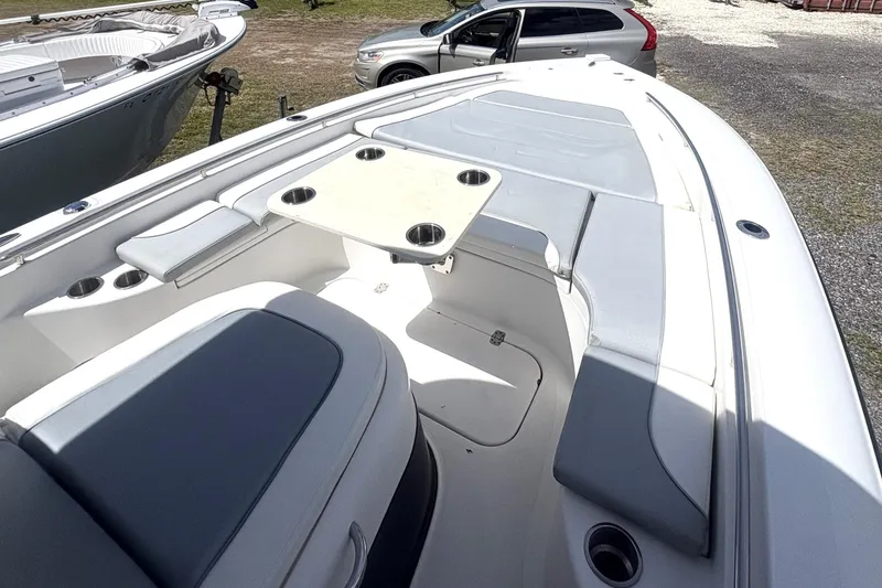 Slide: The Image of 2018 ShearWater 26 Carolina boat interior with seating and table setup. - 4