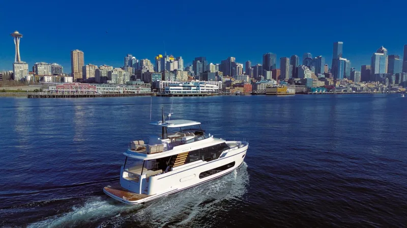 Slide: The Image of Azimut Magellano 60 yacht cruising near a city skyline, 2025 model. - 29