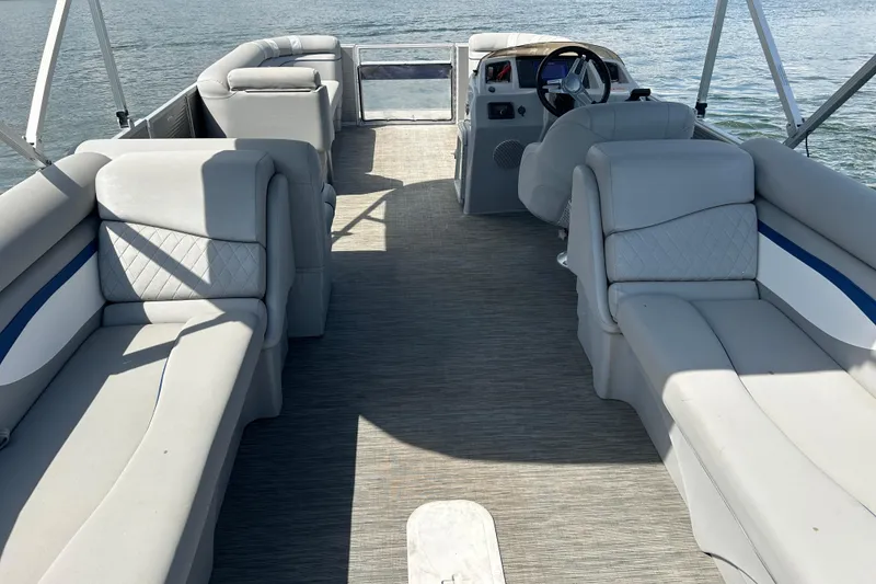 Slide: The Image of 2023 Bennington 22 SSR pontoon boat interior with plush seating and steering console. - 12