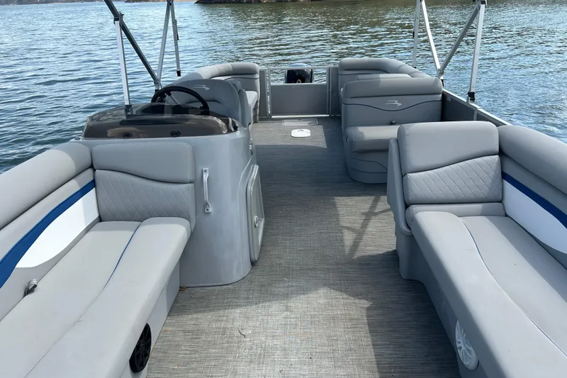 Slide: The Image of 2023 Bennington 22 SSR pontoon boat interior with gray seating and steering console. - 13