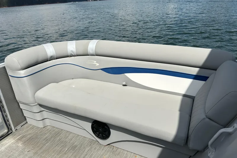 Slide: The Image of 2023 Bennington 22 SSR pontoon boat with comfortable seating, overlooking serene water. - 14