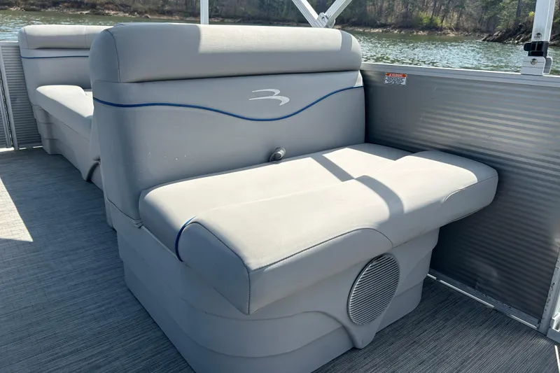 Slide: The Image of 2023 Bennington 22 SSR pontoon boat interior with comfortable seating and scenic lake view. - 16