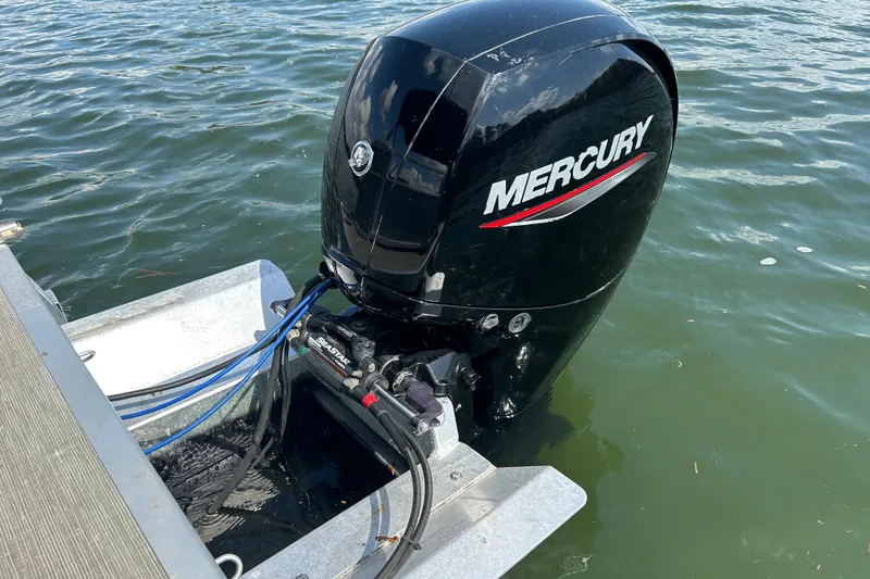 Slide: The Image of 2023 Bennington 22 SSR with Mercury outboard motor on water. - 19