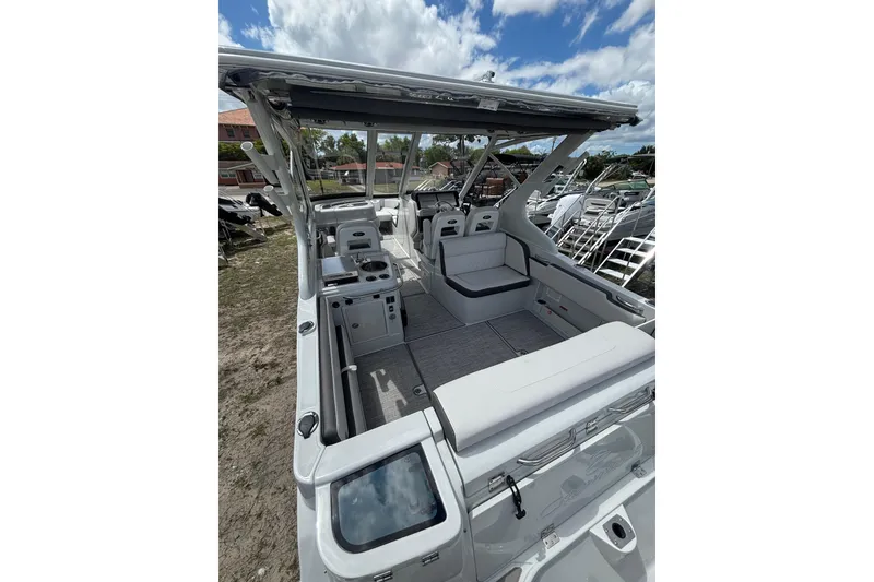 Slide: The Image of 2026 Crownline 280 DC boat interior with spacious seating and modern amenities under a clear sky. - 11