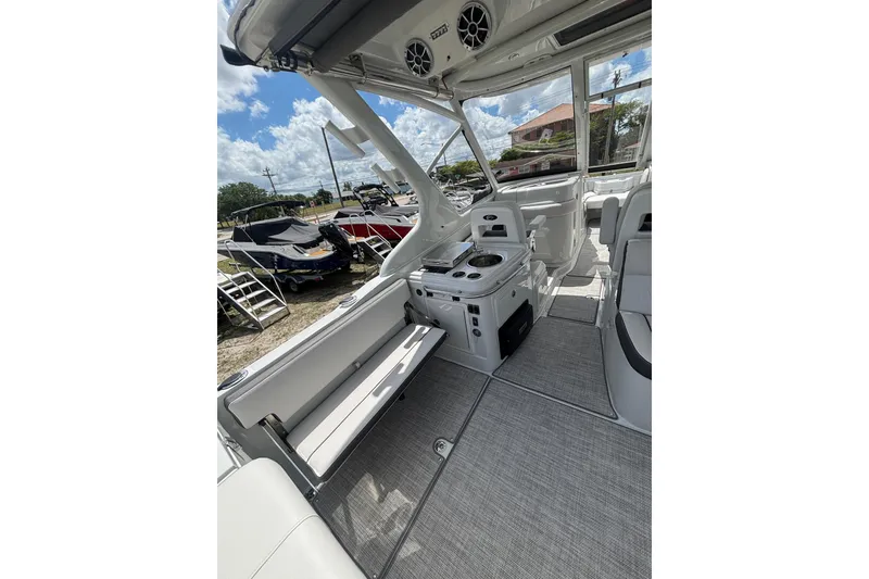Slide: The Image of 2026 Crownline 280 DC boat interior with seating and control panel under a sunny sky. - 12