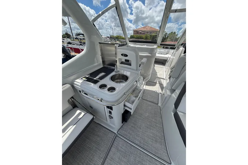 Slide: The Image of 2026 Crownline 280 DC boat interior with sleek kitchen area and modern amenities. - 14