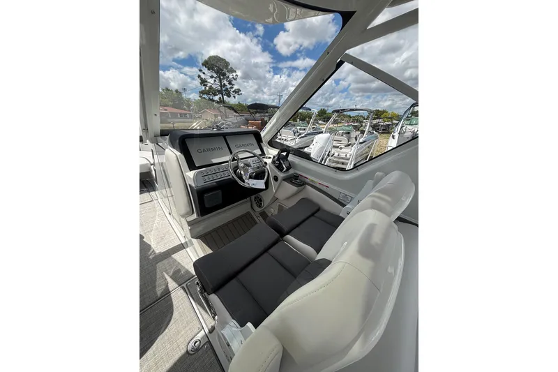 Slide: The Image of Interior view of 2026 Crownline 280 DC boat with modern dashboard and seating. - 16
