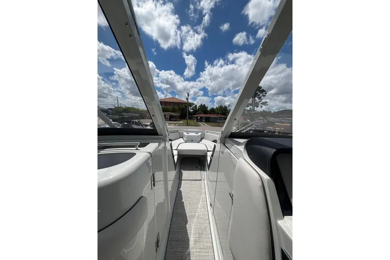 Slide: The Image of 2026 Crownline 280 DC boat interior with sleek design under a bright blue sky. - 18