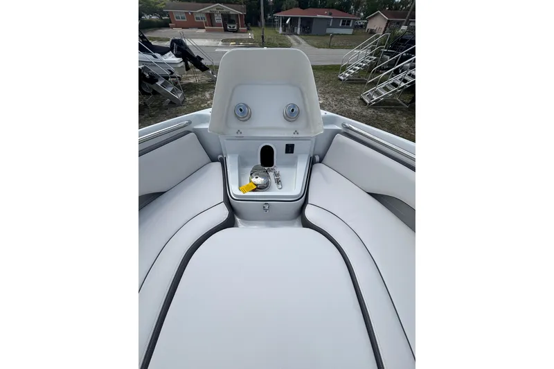 Slide: The Image of 2026 Crownline 280 DC boat interior with seating and storage compartment. - 20