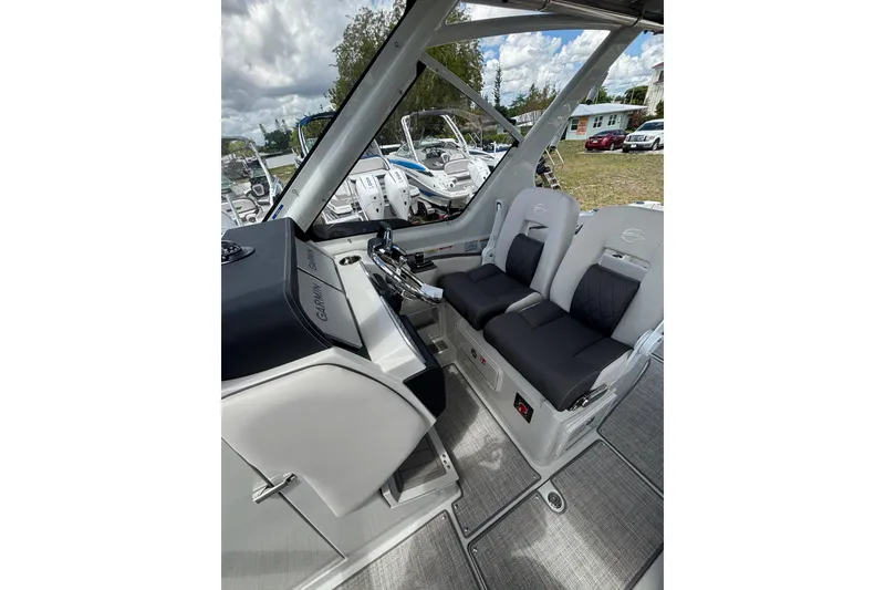 Slide: The Image of Interior of 2026 Crownline 280 DC boat with dual seats and modern dashboard. - 23