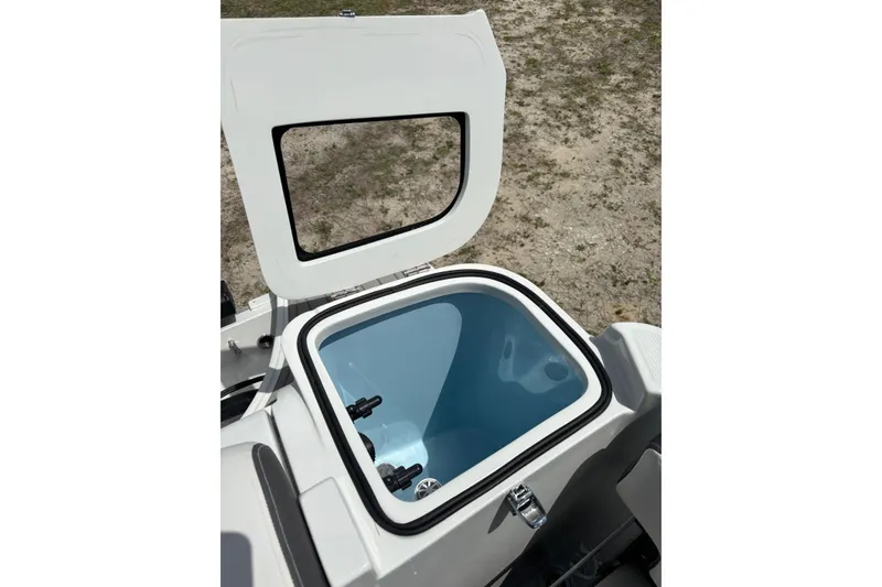 Slide: The Image of Open storage compartment on 2026 Crownline 280 DC boat, showcasing interior design. - 4
