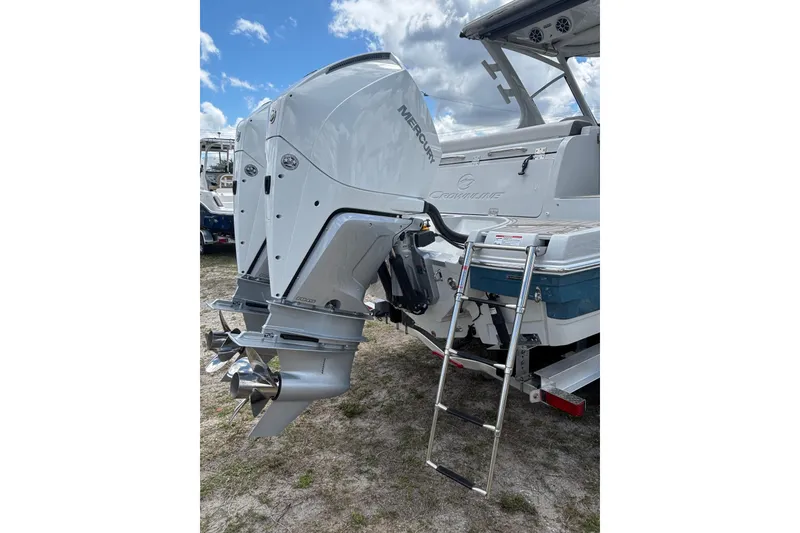 Slide: The Image of Crownline 280 DC 2026 boat with Mercury outboard motor and boarding ladder. - 6