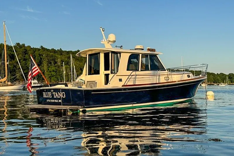 The Image of 2007 Grand Banks 39 Eastbay SX boat on calm water with American flag. - 1