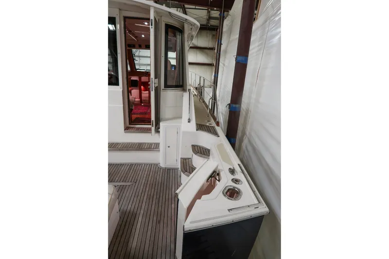 Slide: The Image of 2007 Grand Banks 39 Eastbay SX yacht interior with wooden deck and open door. - 11