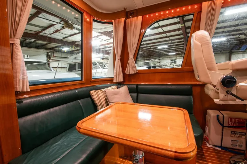 Slide: The Image of Luxurious 2007 Grand Banks 39 Eastbay SX yacht interior with leather seating and wooden table. - 19