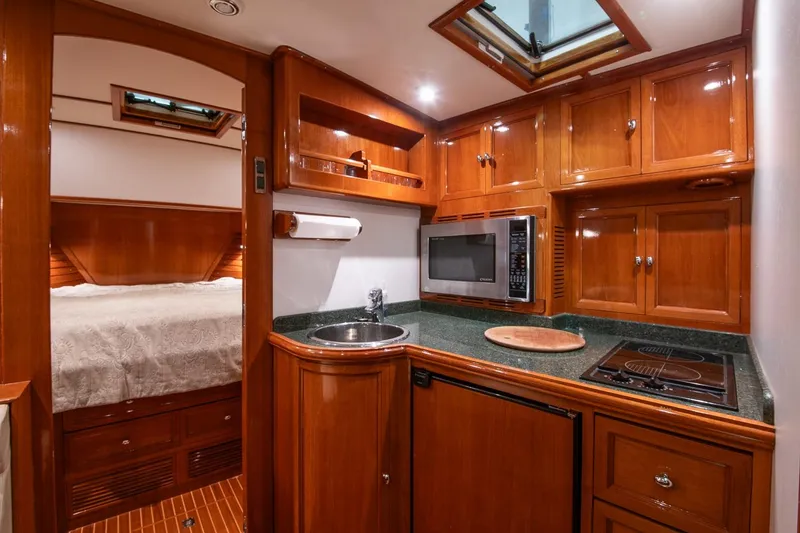 Slide: The Image of Luxurious 2007 Grand Banks 39 Eastbay SX yacht interior with wood cabinetry and modern kitchen amenities. - 27