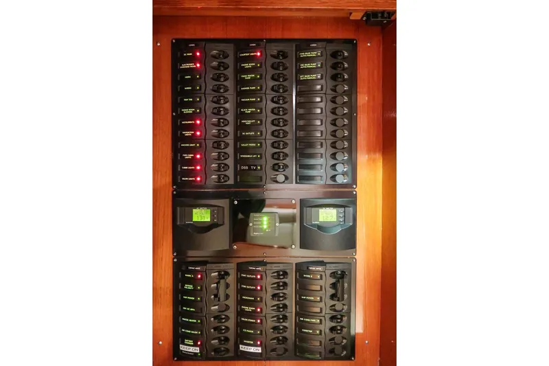 Slide: The Image of Electrical panel of 2007 Grand Banks 39 Eastbay SX yacht with labeled switches and displays. - 40