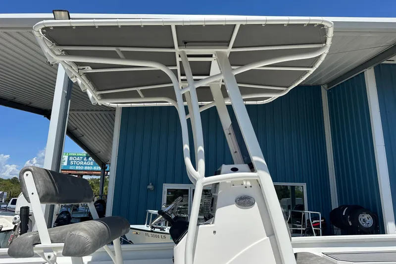Slide: The Image of 2024 Avid 23 Mag boat with T-top and seating, displayed at a storage facility. - 10