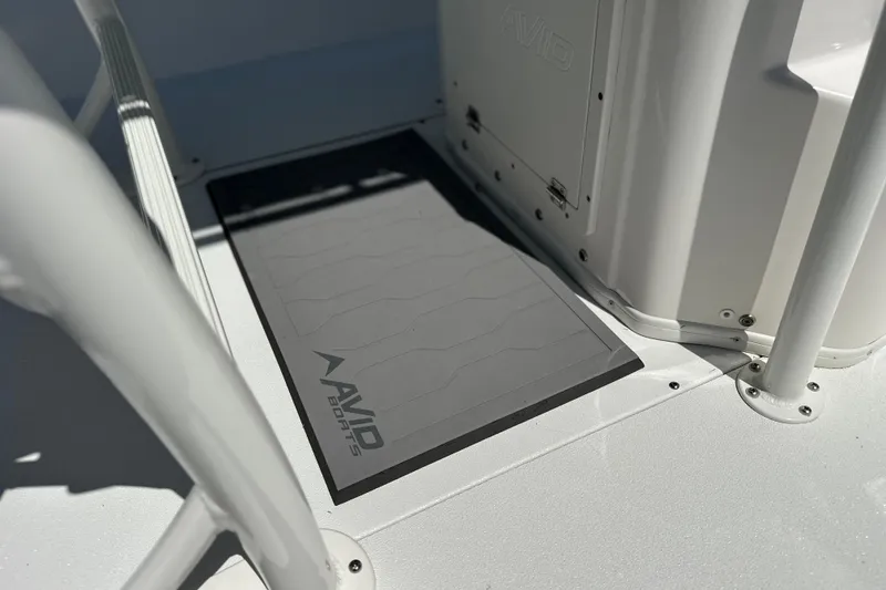 Slide: The Image of Avid 23 Mag 2024 boat deck with branded mat and sleek design. - 11
