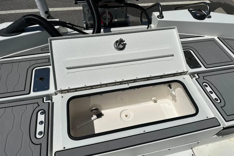 Slide: The Image of Open storage compartment on 2024 Avid 23 Mag boat, showcasing interior design. - 12
