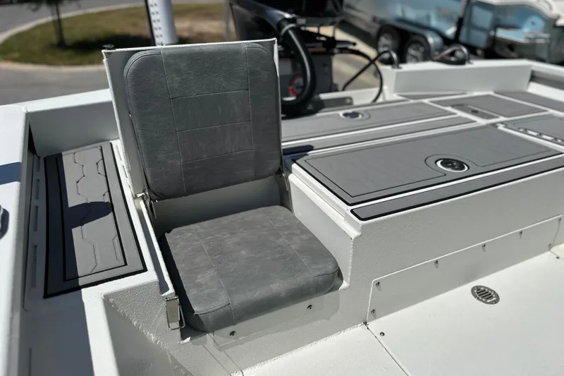 Slide: The Image of 2024 Avid 23 Mag boat interior with gray seating and storage compartments. - 13