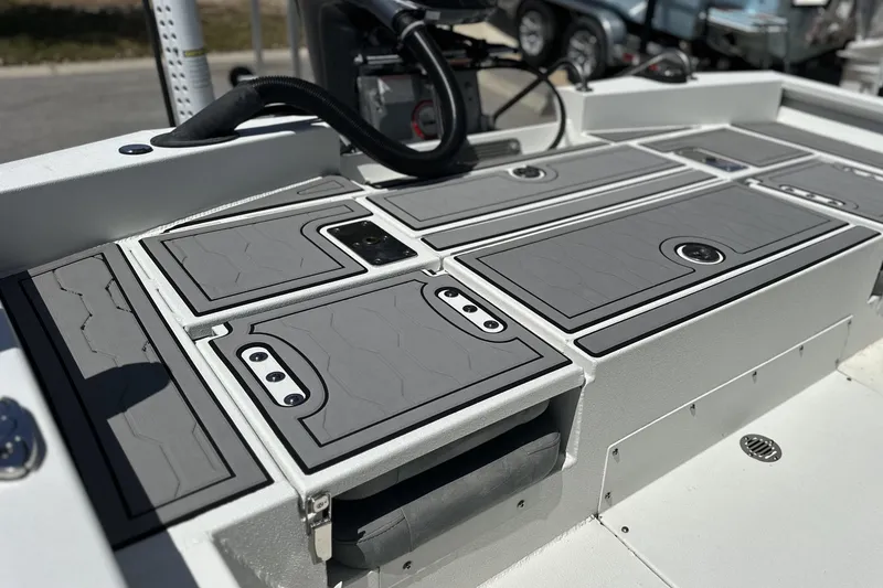 Slide: The Image of 2024 Avid 23 Mag boat deck with sleek gray storage compartments. - 15