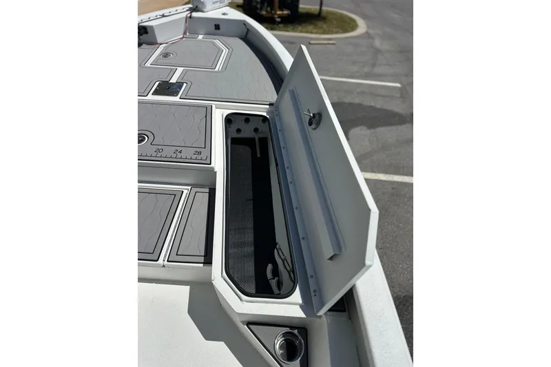 Slide: The Image of Open storage compartment on 2024 Avid 23 Mag boat deck, showcasing sleek design and functionality. - 16
